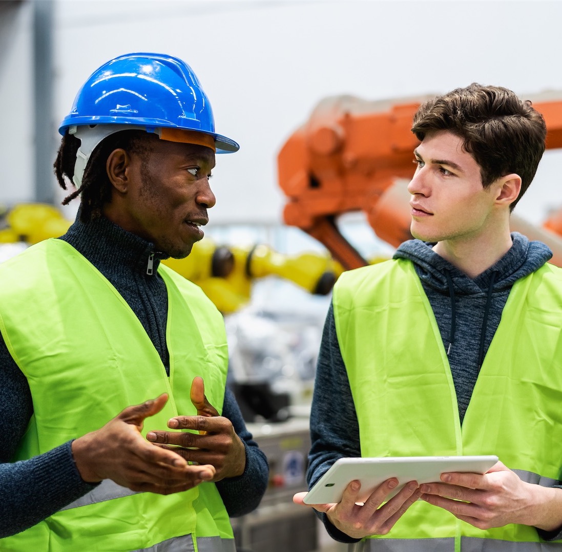 two workers on ipad talking